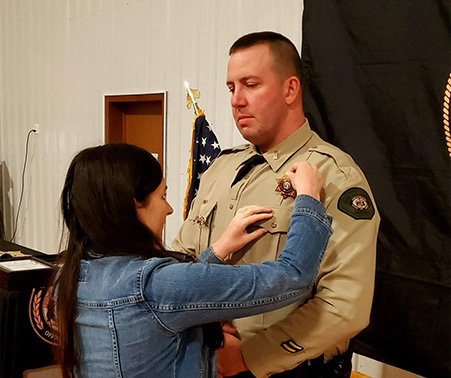 Ashley Roberts pinning Matt's Lieutenant badge