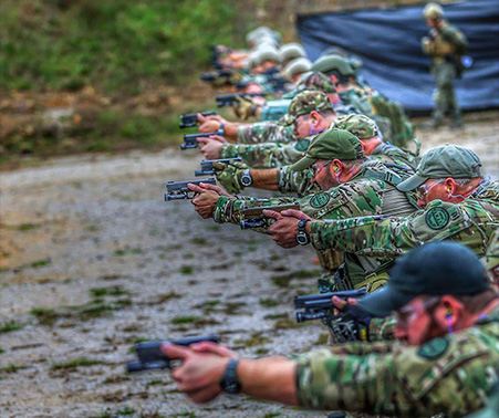 Matt Roberts with other Howell County SWAT team members at the firing range holding handguns