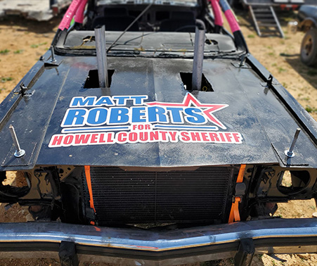 Demolition derby car with a Matt Roberts For Howell County Sheriff logo on the hood