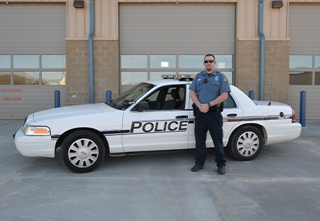 Matt Roberts in front of a West Plains Police Department Car